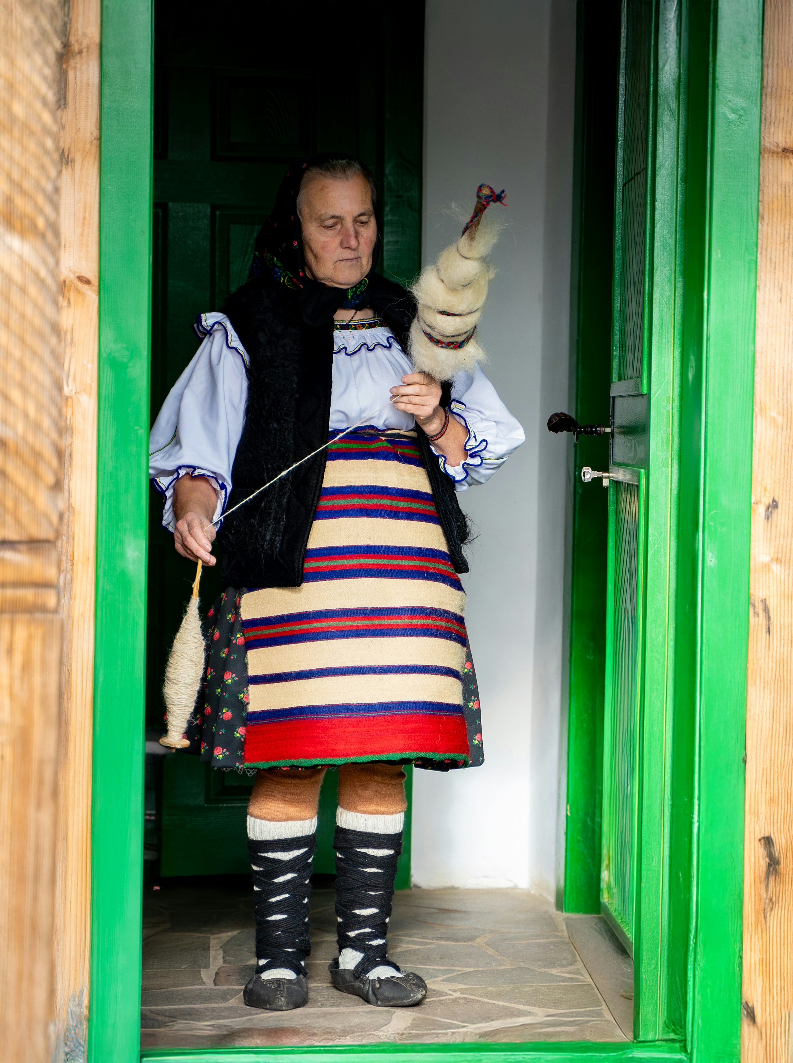 A woman in a kilt is holding a bag