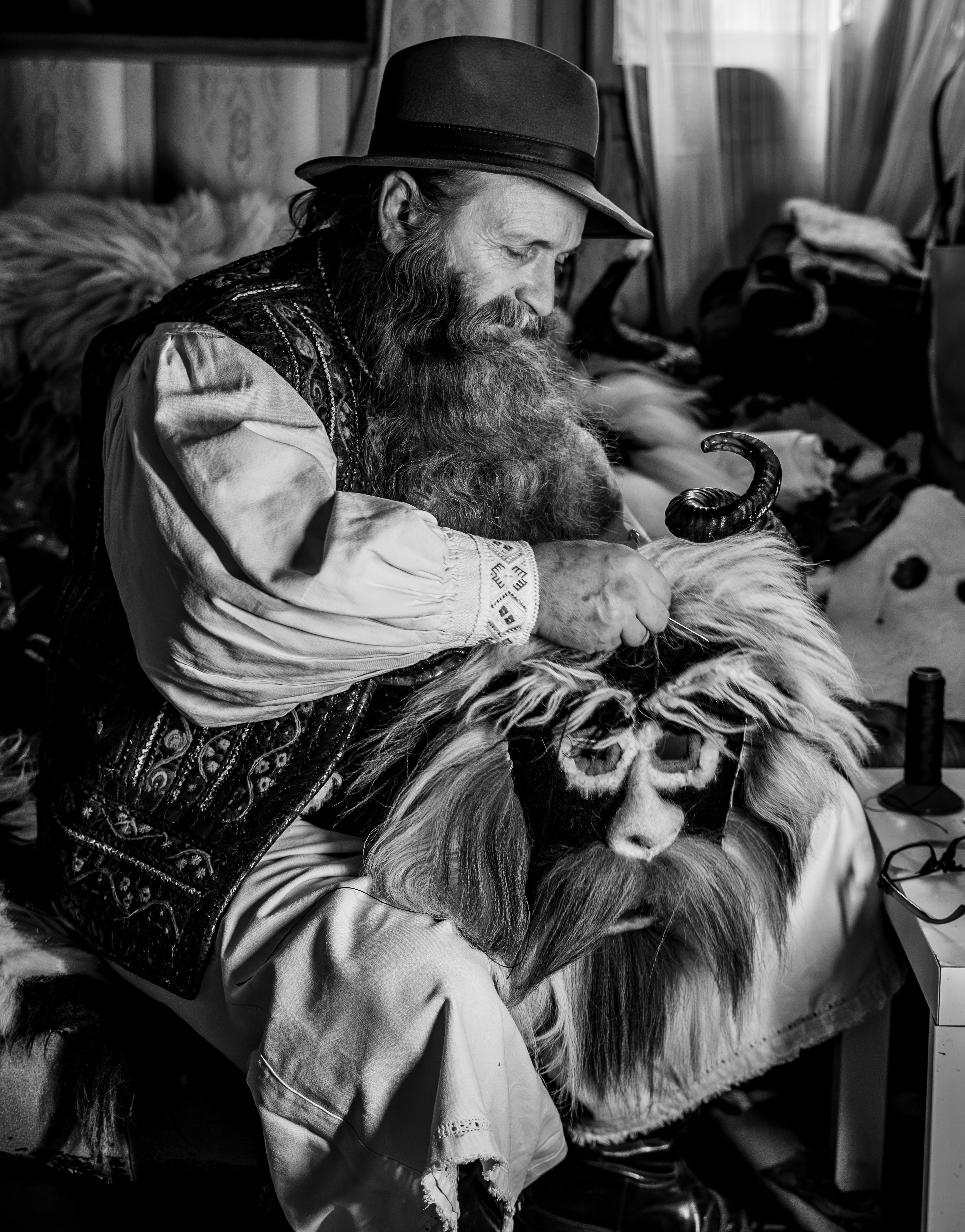 A man sitting on a chair with a dog in his lap