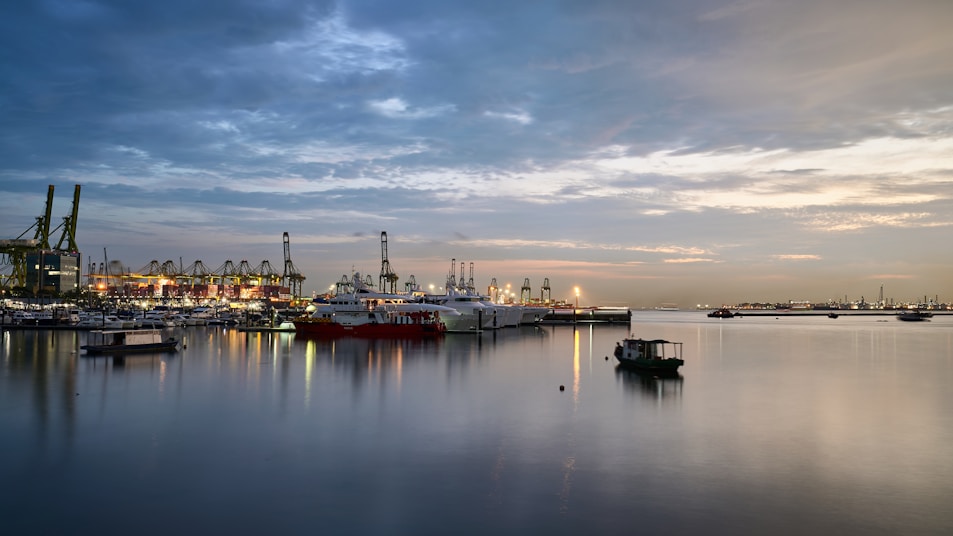 A harbor filled with lots of boats under a cloudy sky