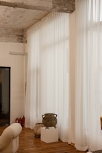 A living room filled with furniture and a large window