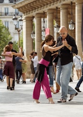 A couple of people that are dancing in the street