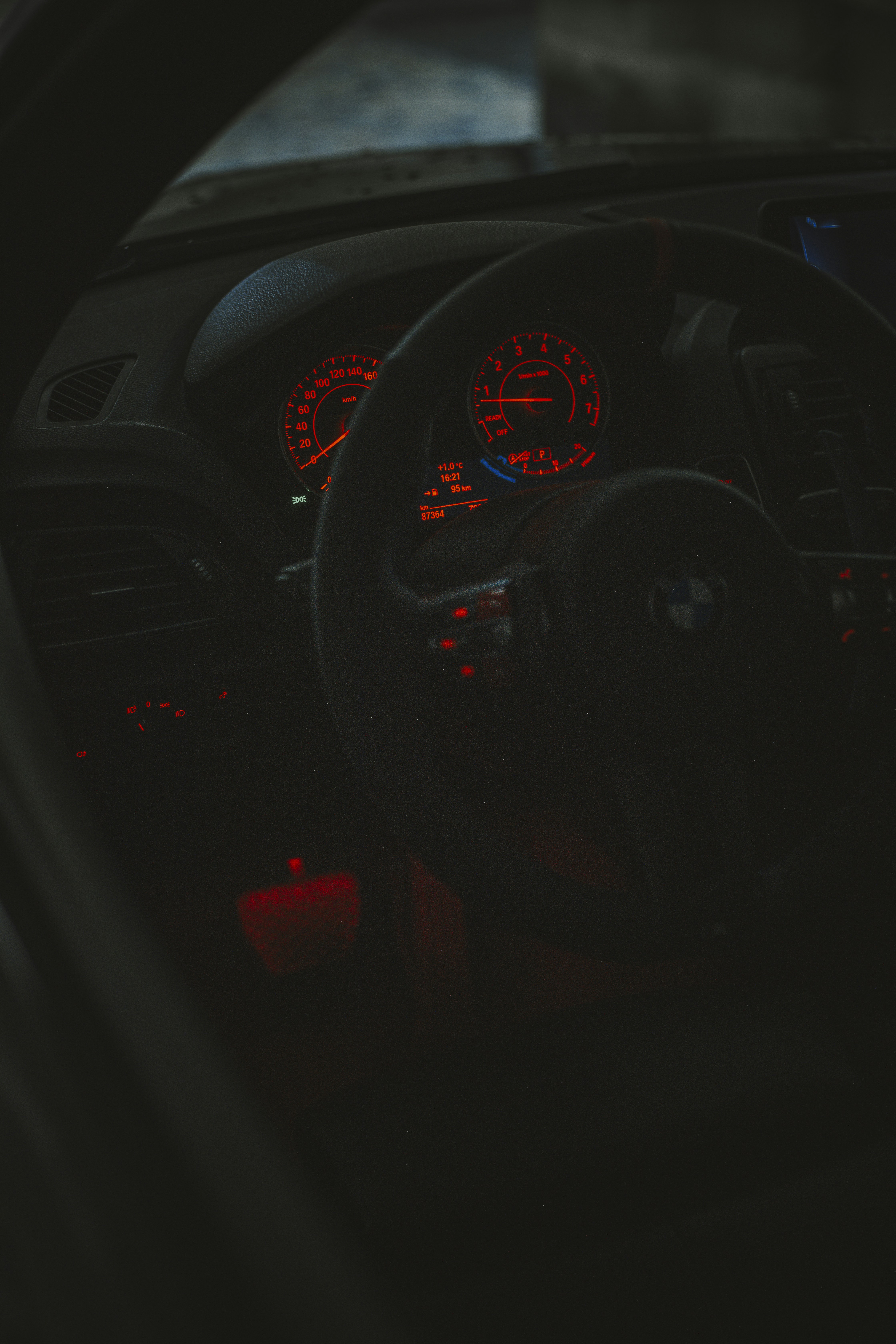 The dashboard of a car with red lights