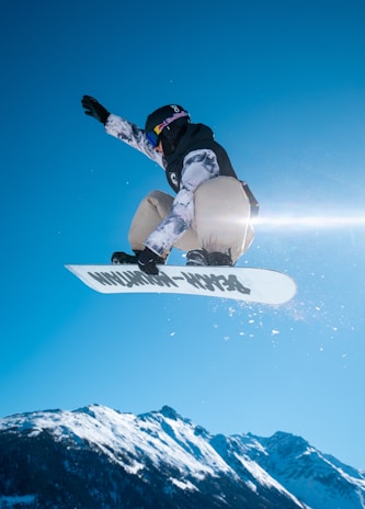 A person on a snowboard jumping in the air