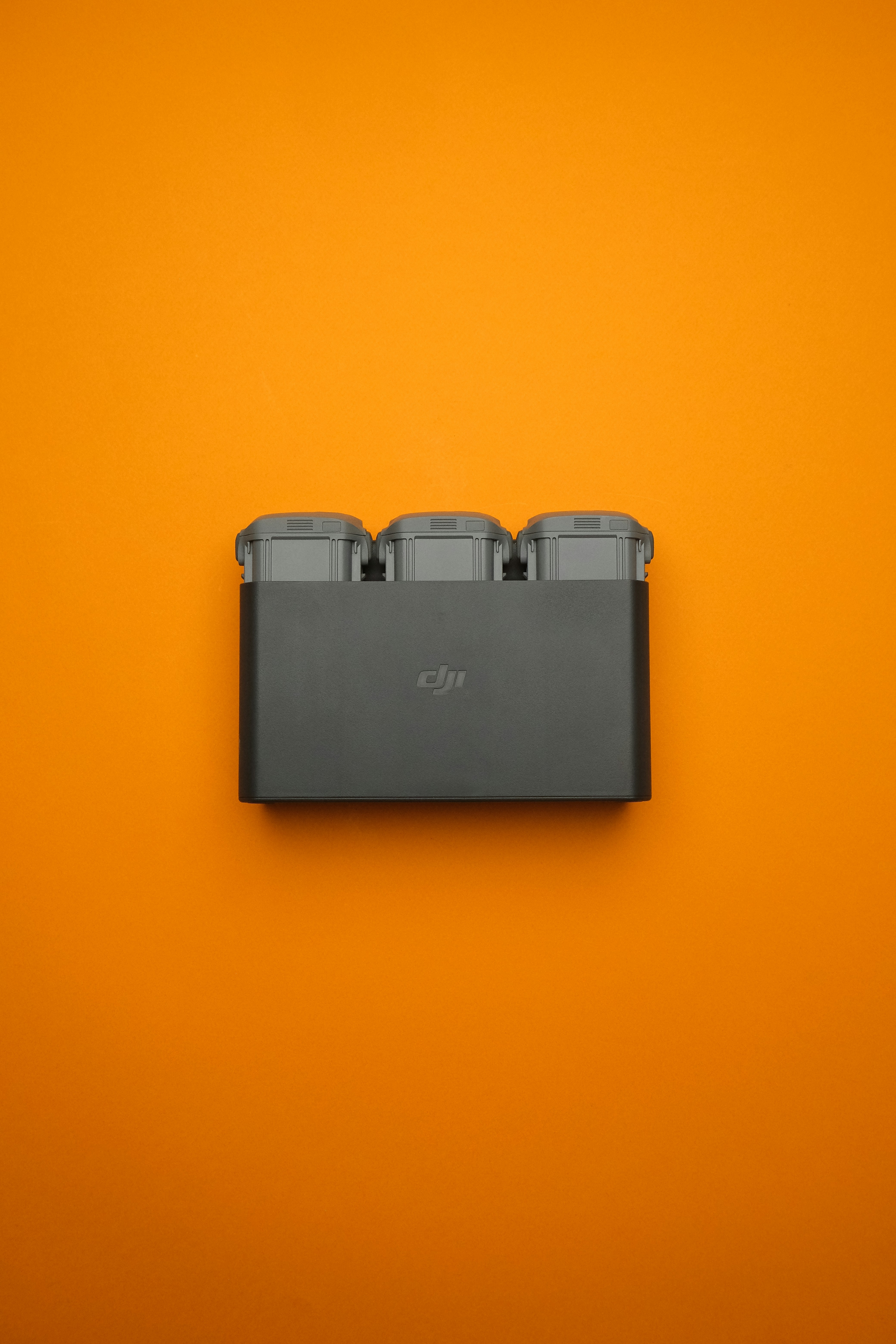 An orange wall with a black object on it