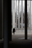 A person is walking through an empty parking lot