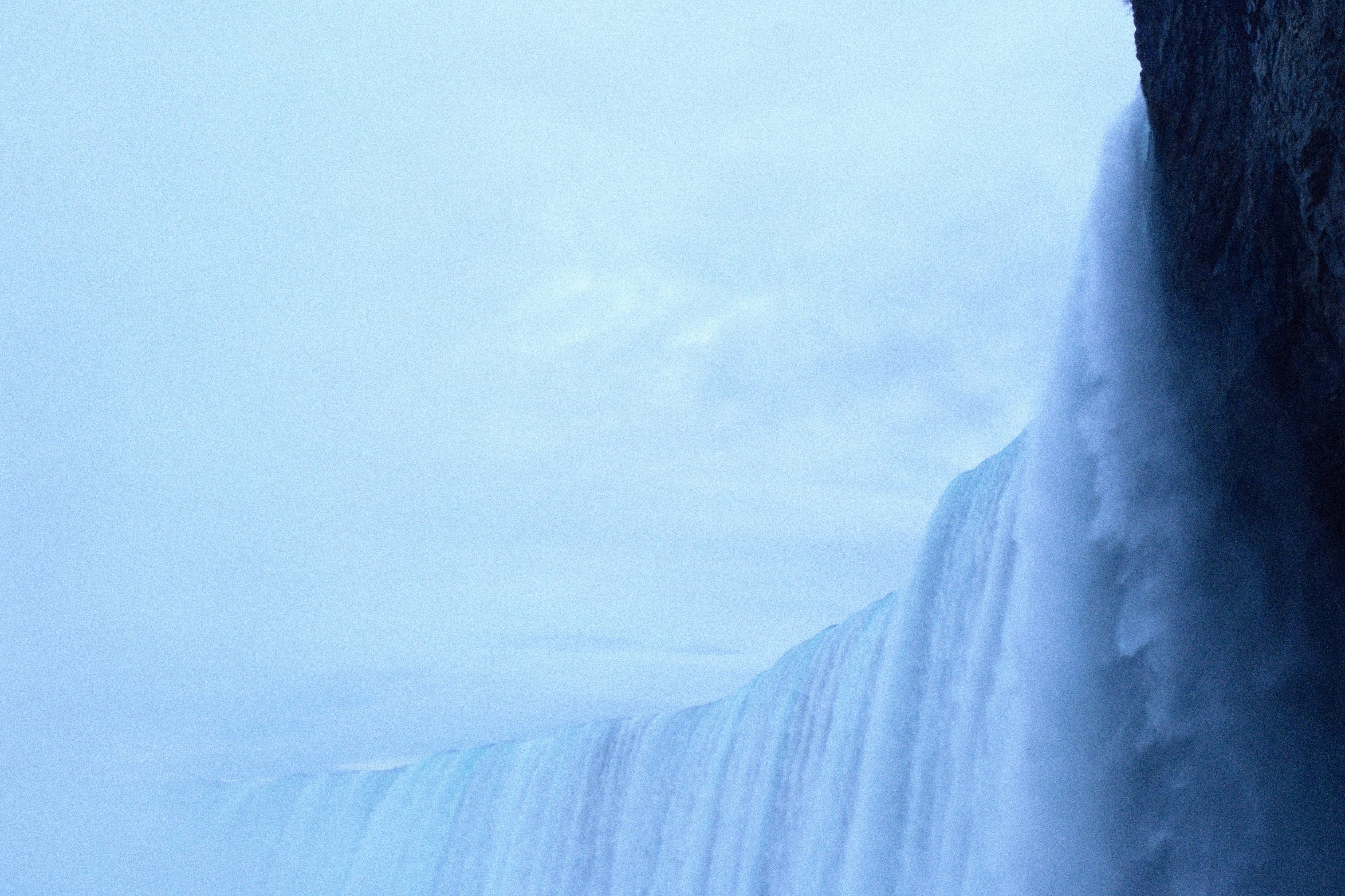 A man standing in front of a waterfall