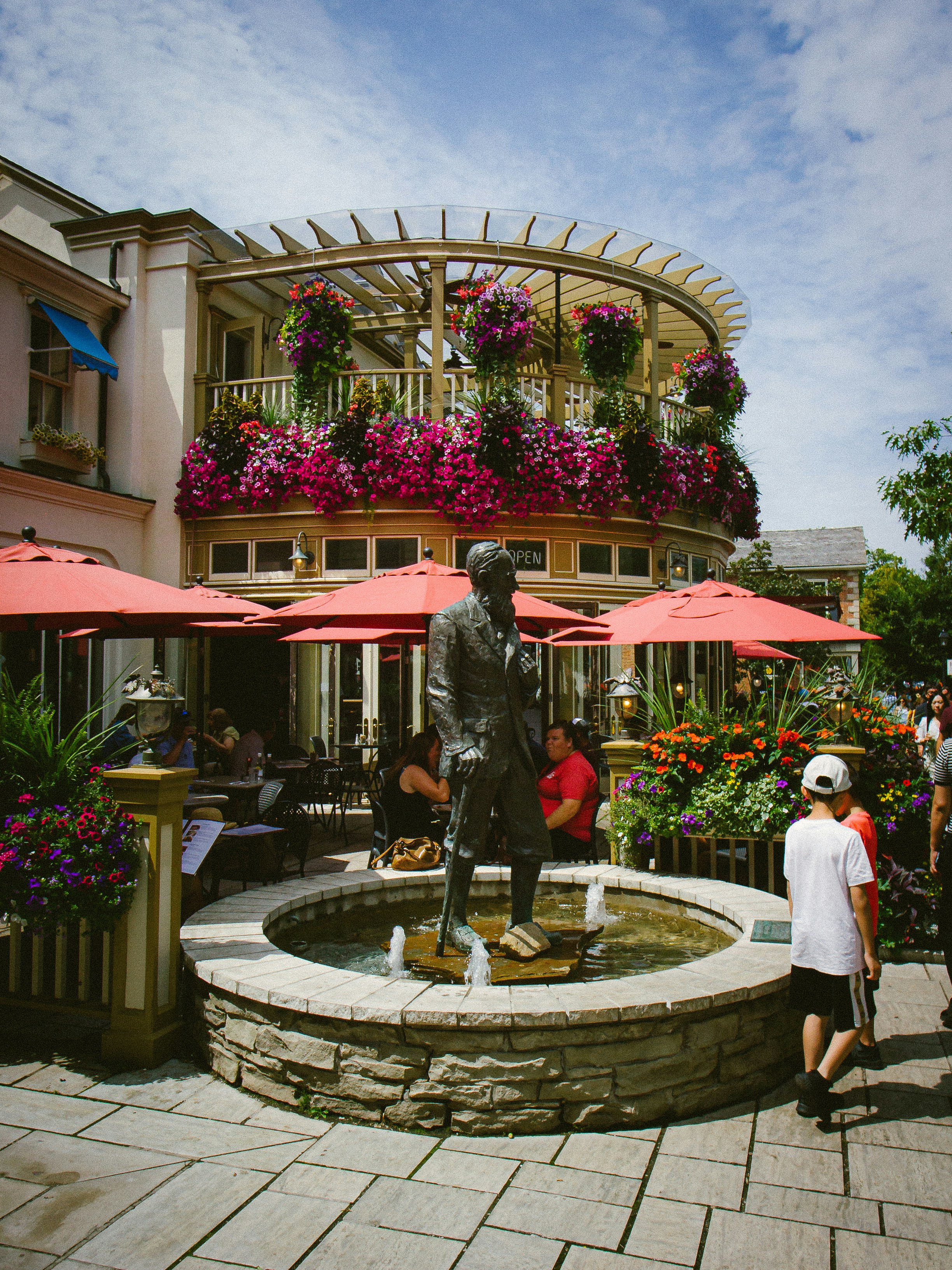 A group of people standing around a fountain