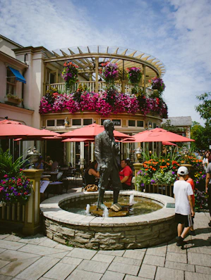 A group of people standing around a fountain