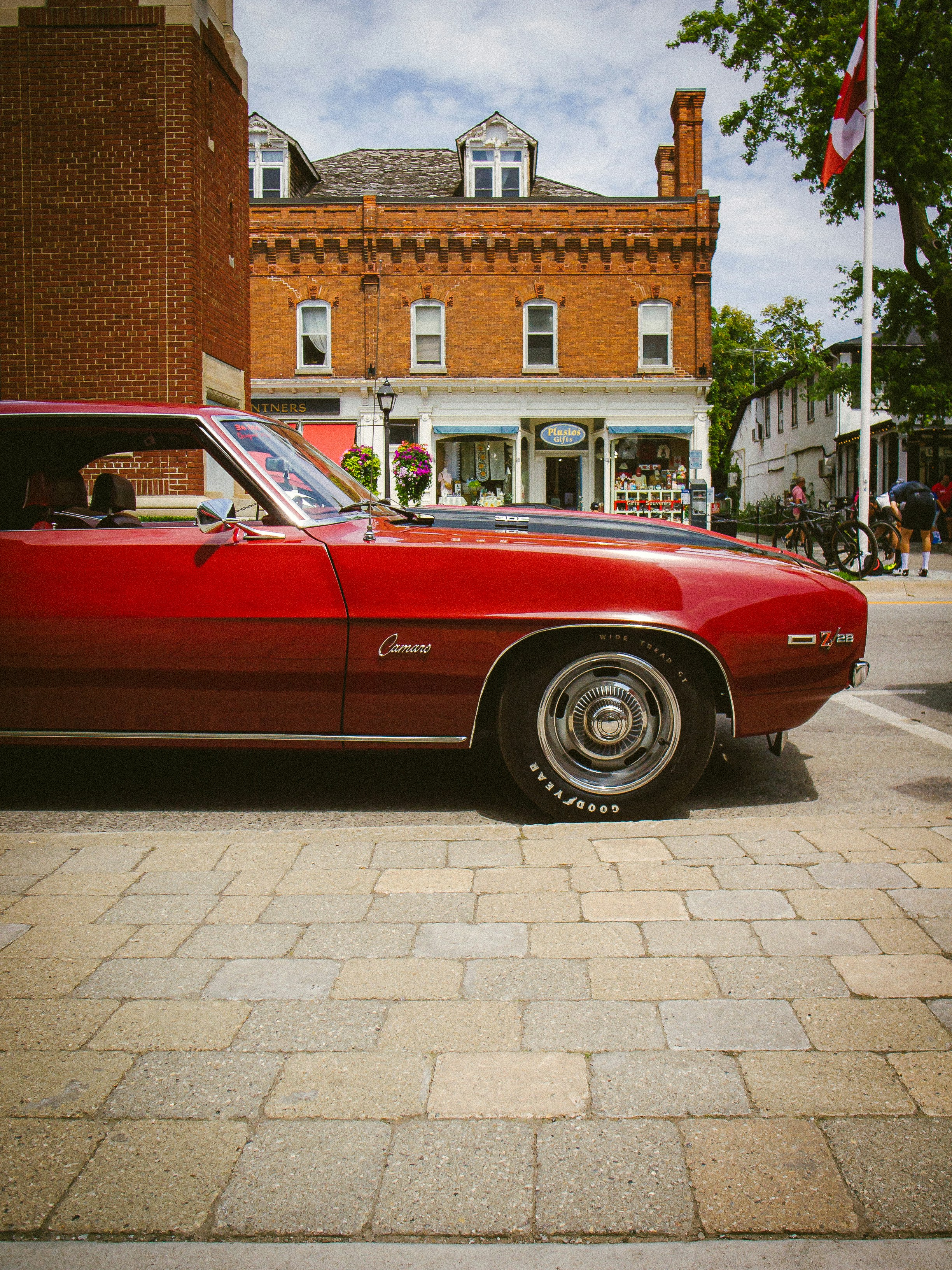 A red car parked on the side of the road