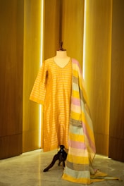 A yellow and pink striped dress on a mannequin