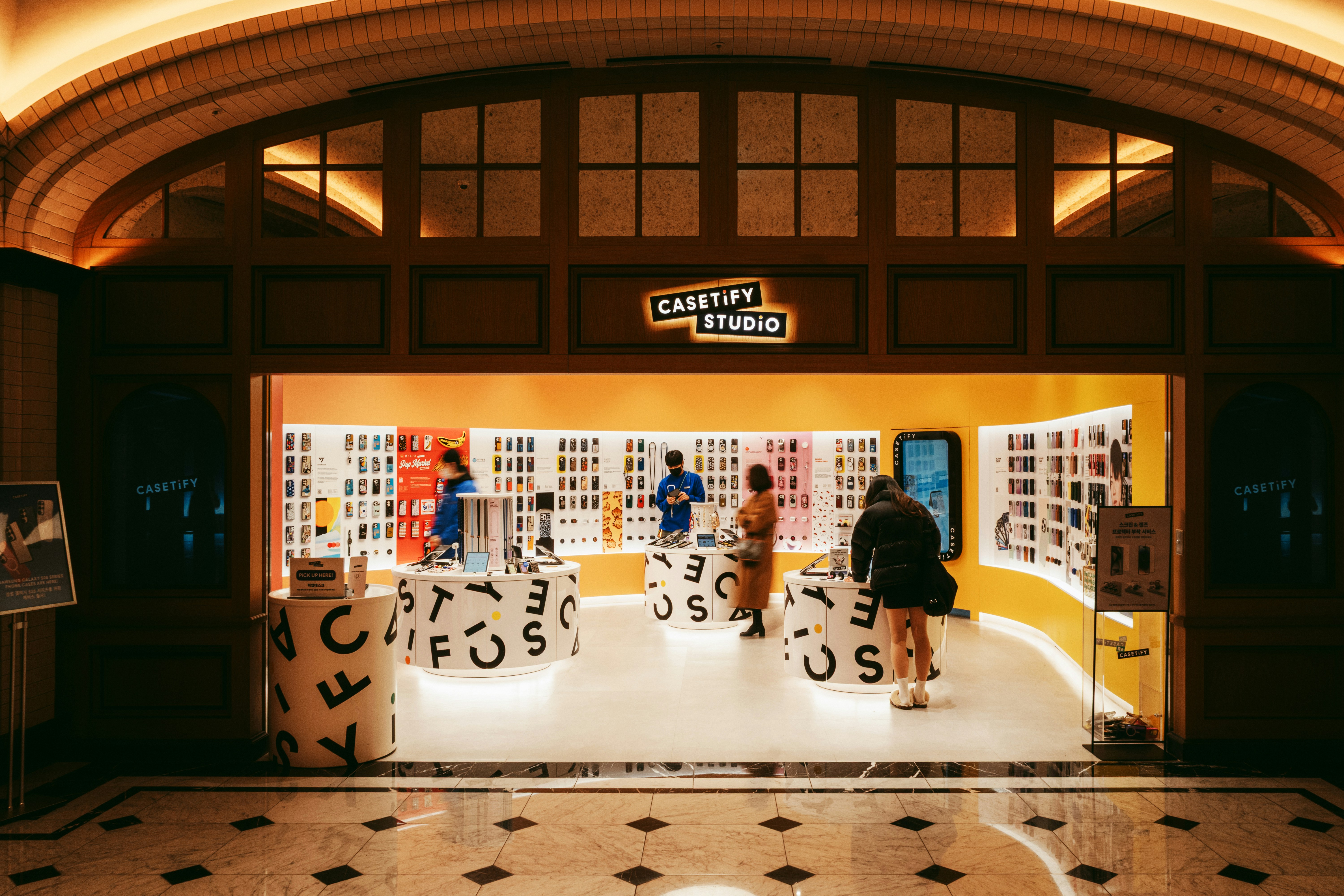 A group of people standing inside of a building
