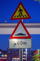 A couple of street signs sitting on top of a metal pole