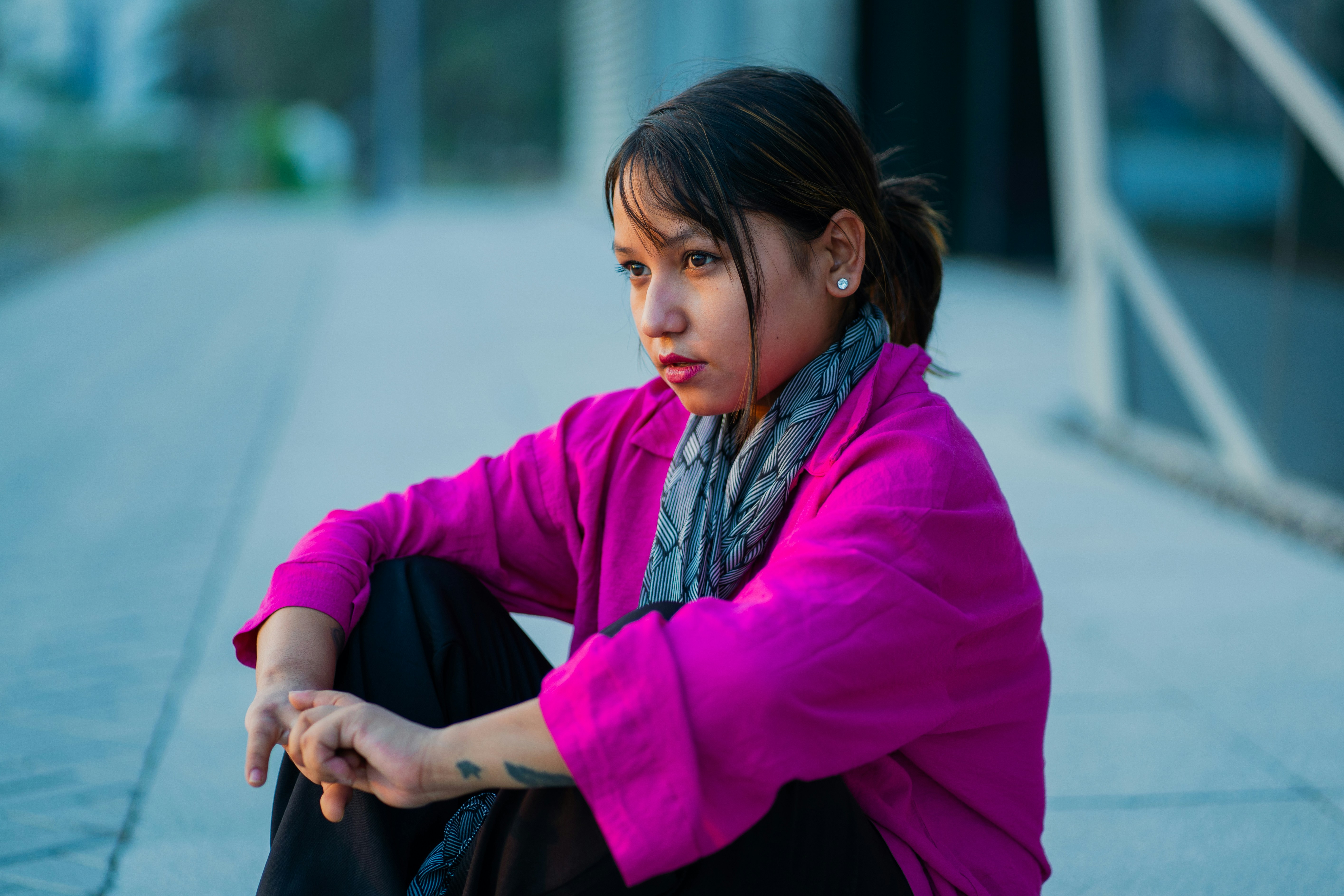 A woman sitting on the ground with her legs crossed