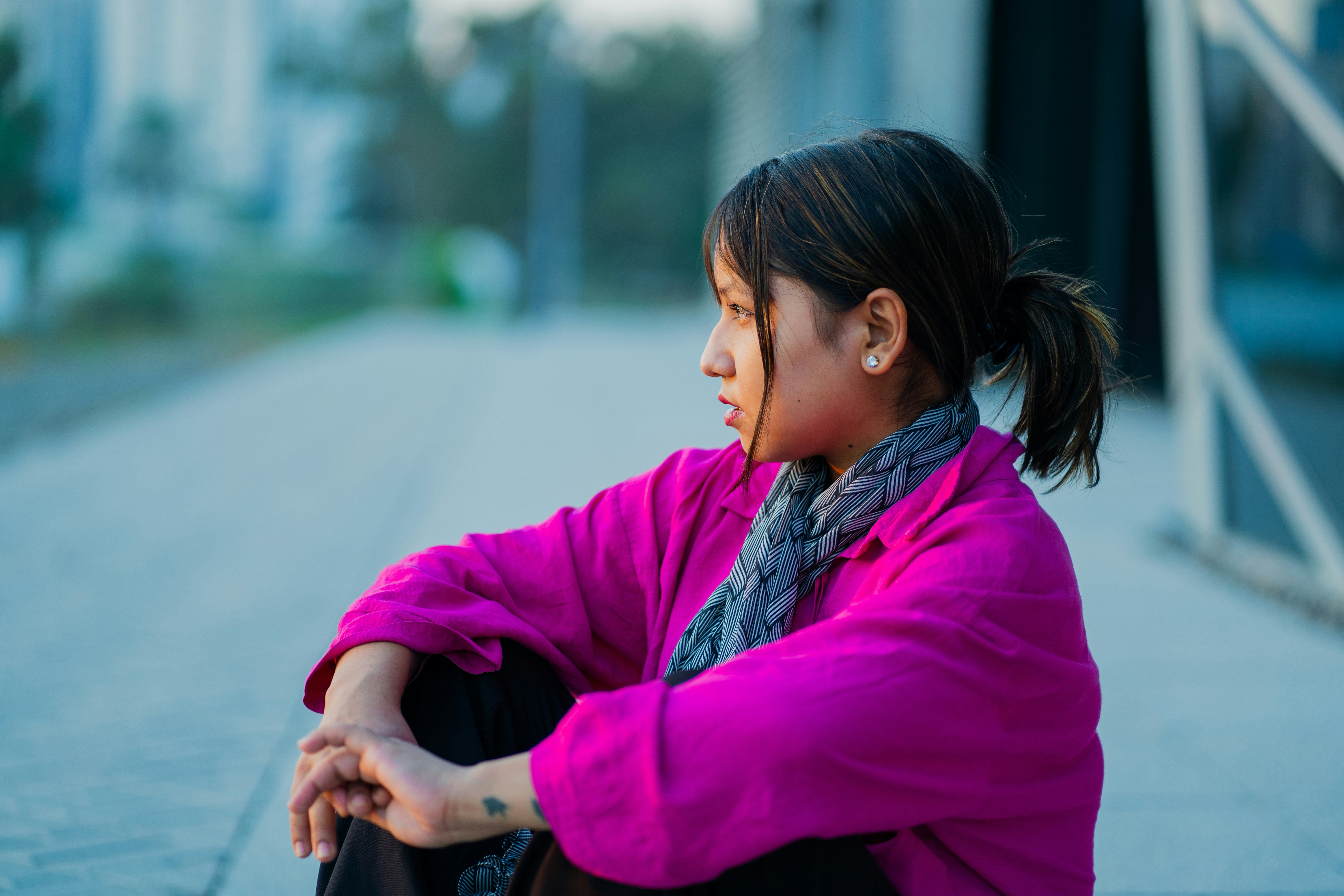A woman sitting on the ground with her arms crossed