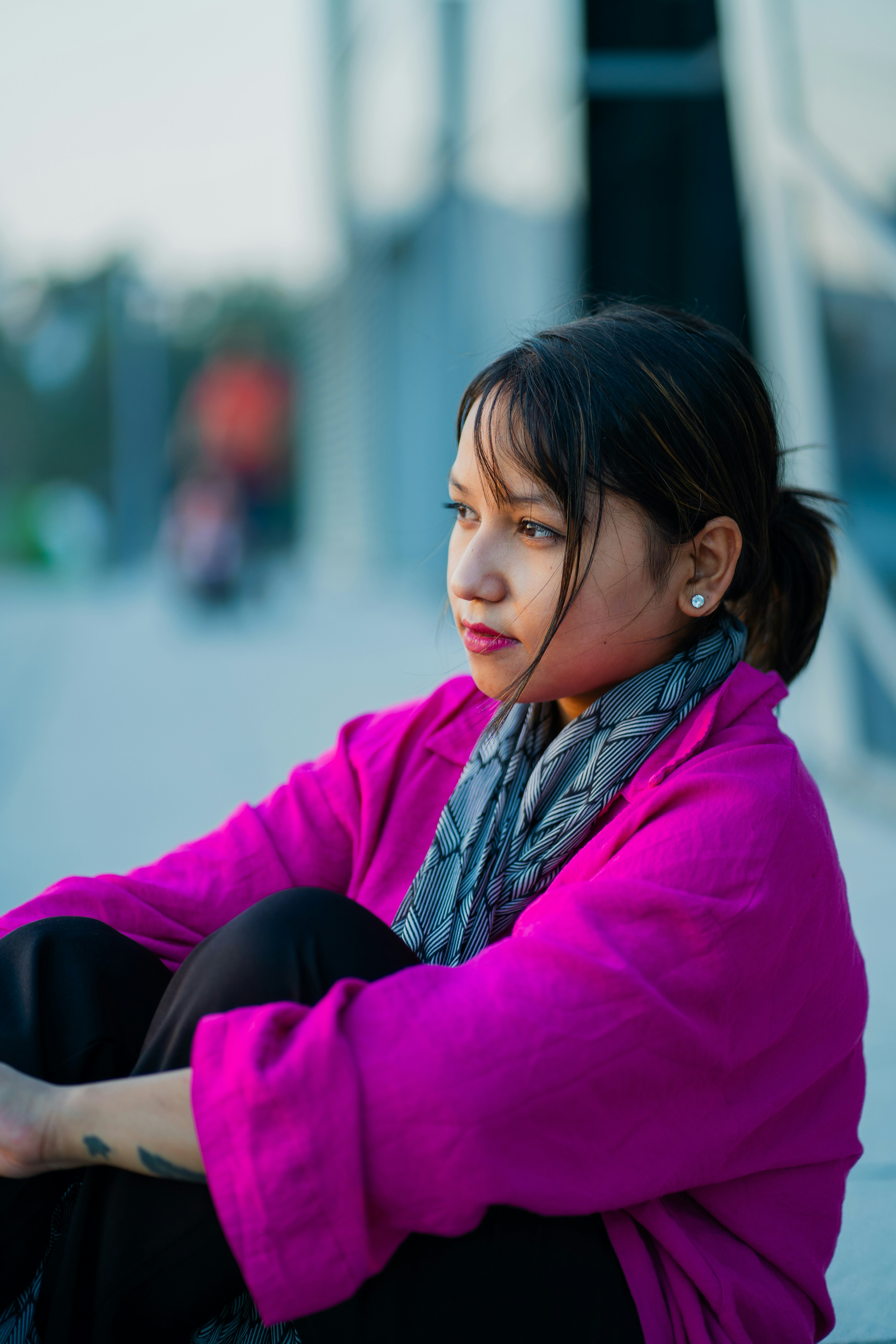 A woman sitting on the ground with her legs crossed