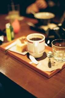 A wooden tray with a cup of coffee on it