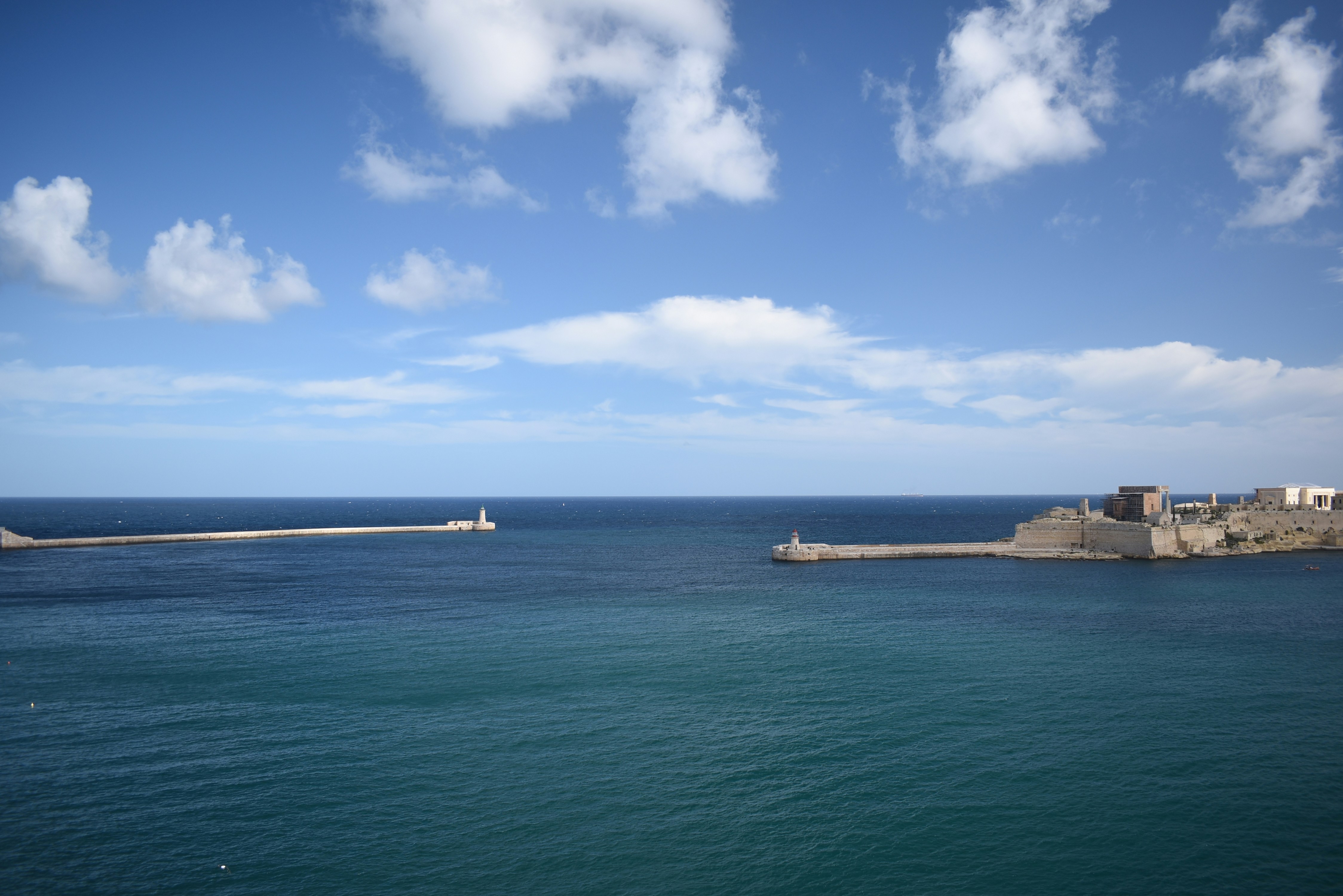 A body of water with a small island in the middle of it
