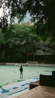 A group of people standing on top of a tennis court