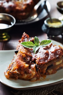 A piece of lasagna on a white plate