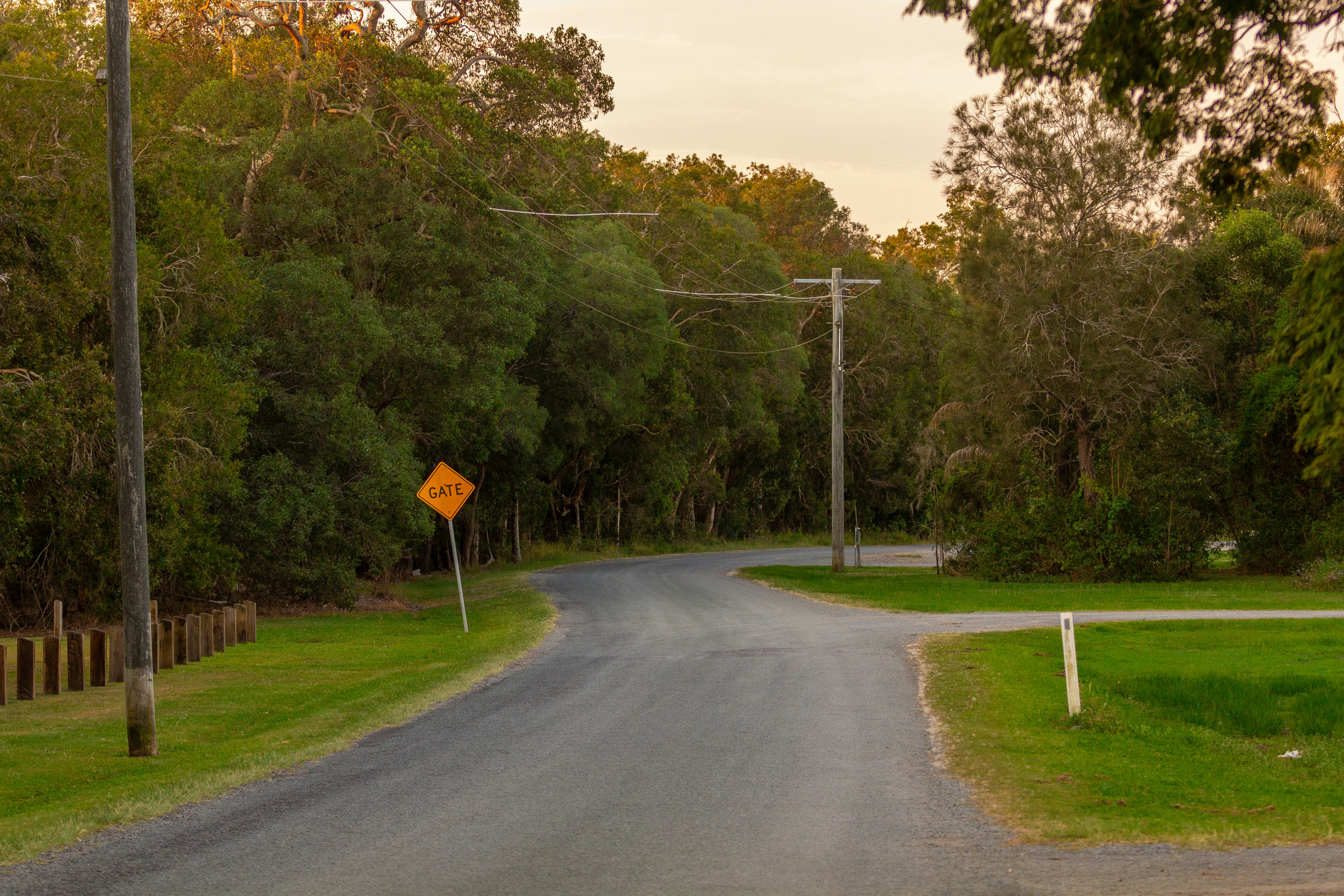 A road with a yellow sign on the side of it