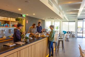 A group of people standing at a counter in a restaurant