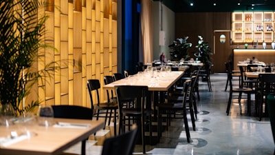 A restaurant with tables, chairs, and a bar