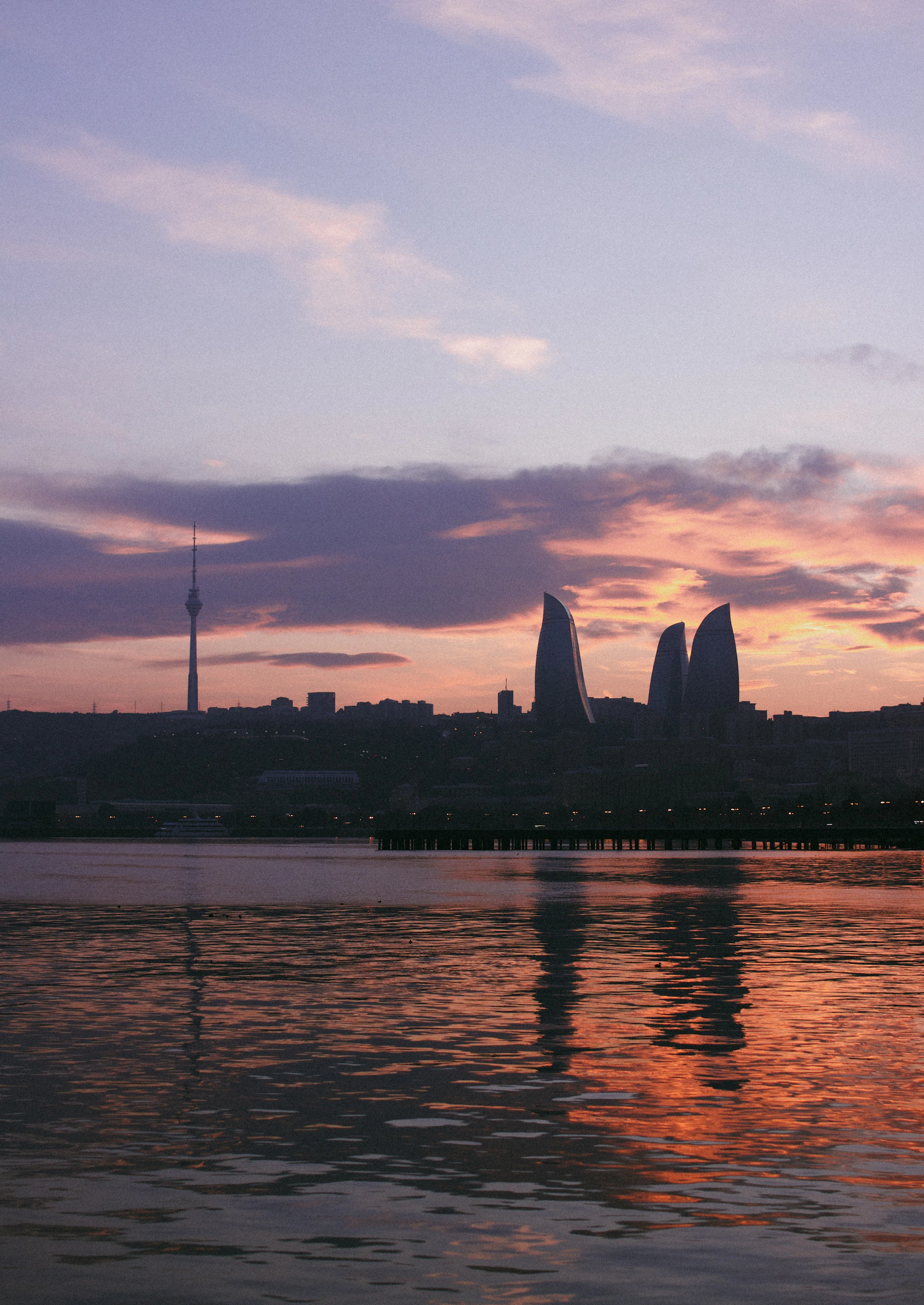 A body of water with a city in the background
