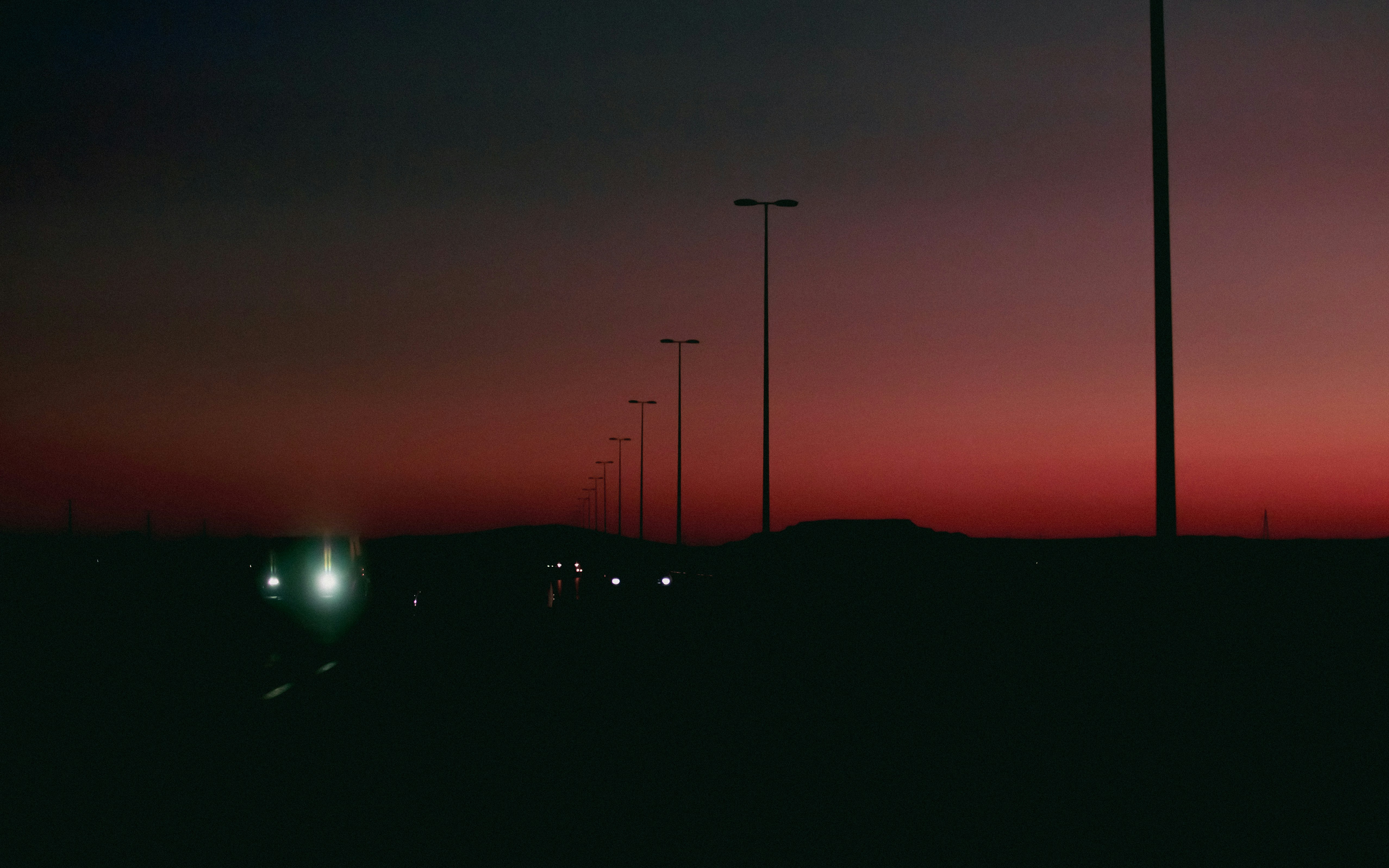 A car driving down a road at night