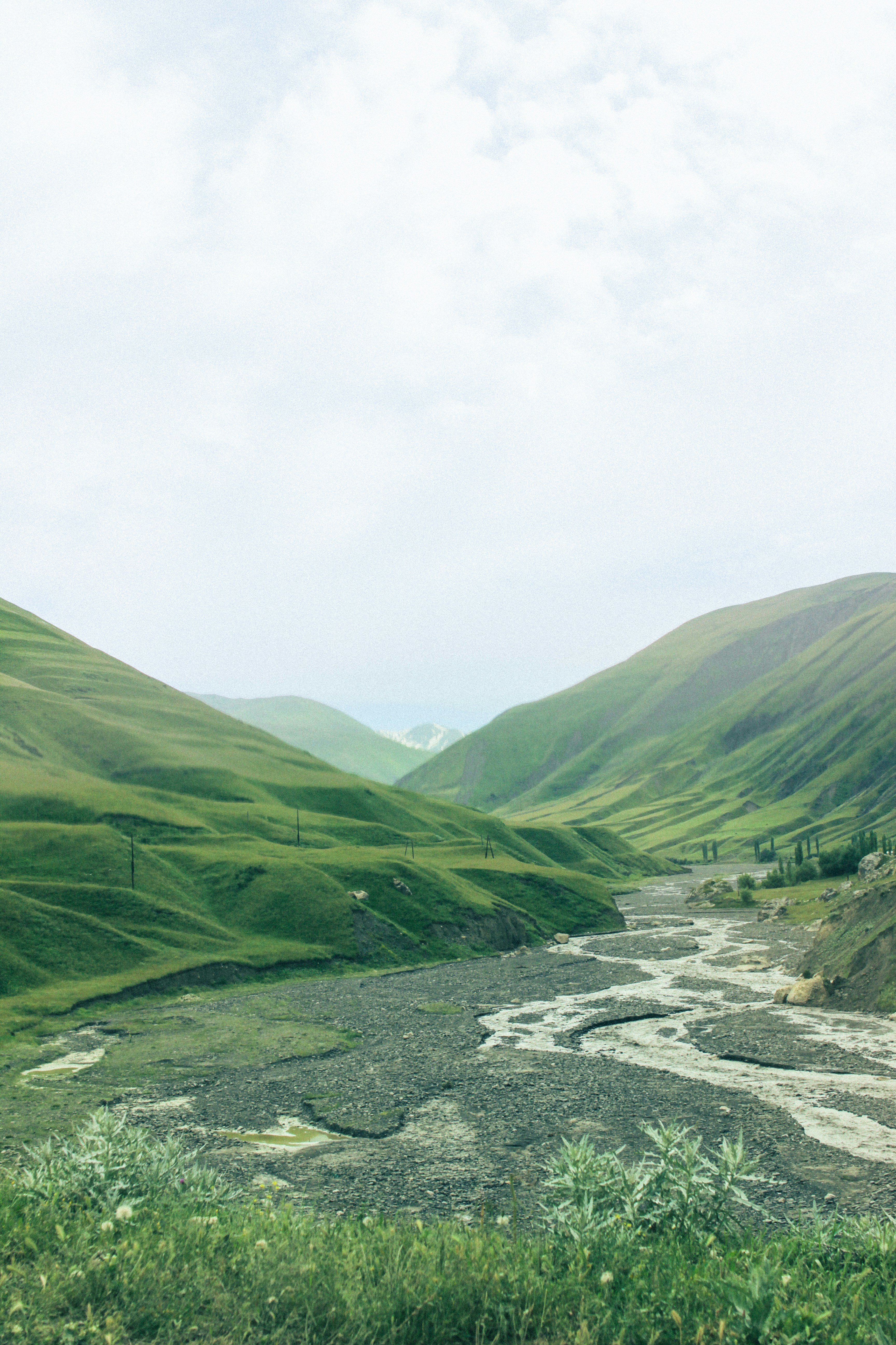 A river running through a lush green valley