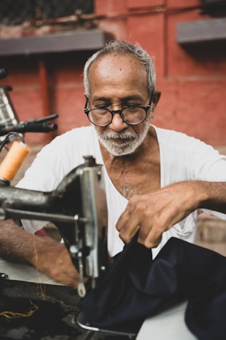 A man is working on a sewing machine