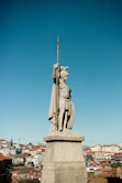 A statue of a man holding a cross