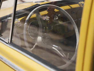 A close up of a yellow car with a steering wheel