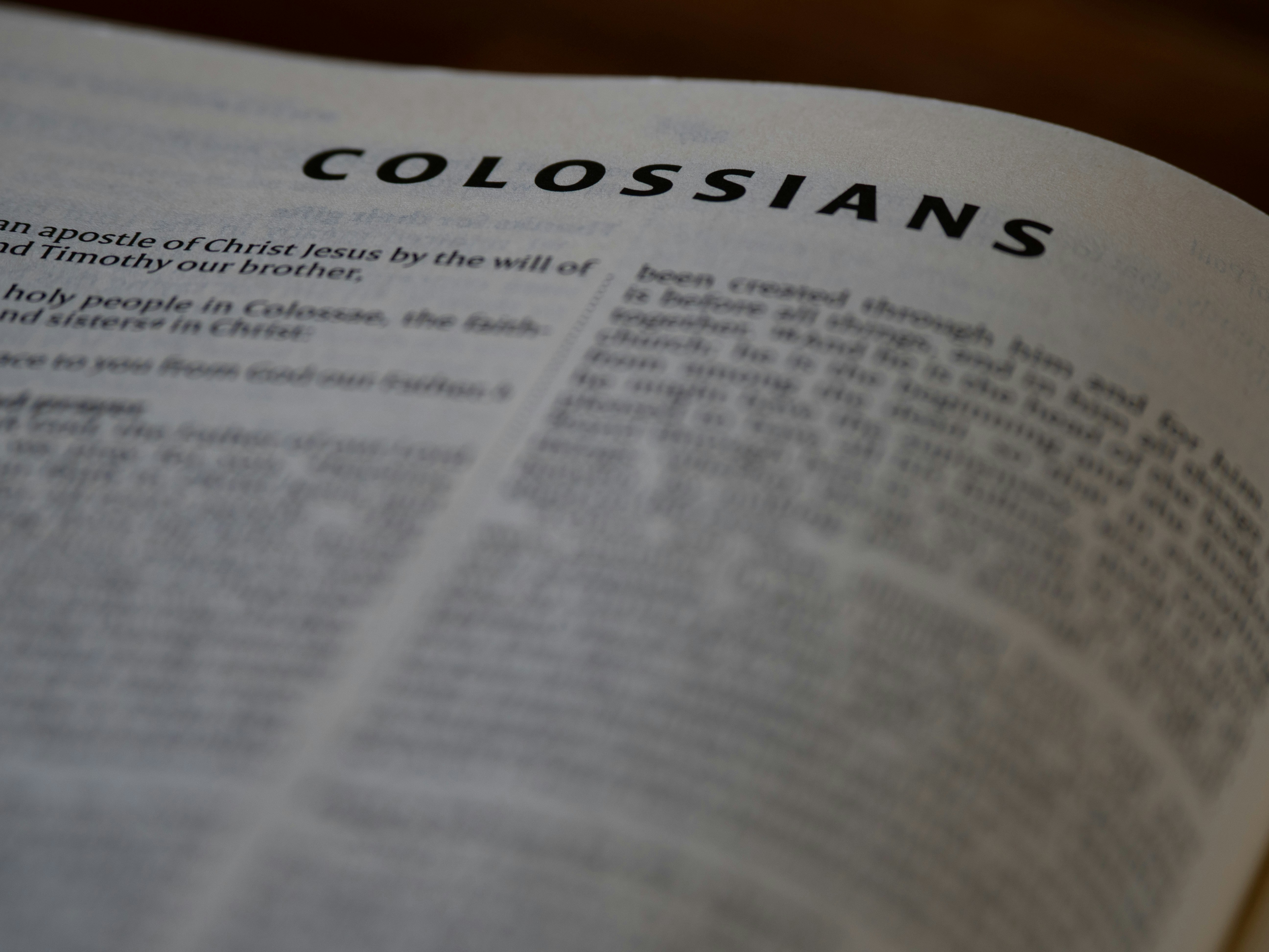 A close up of a book with the word colossians on it