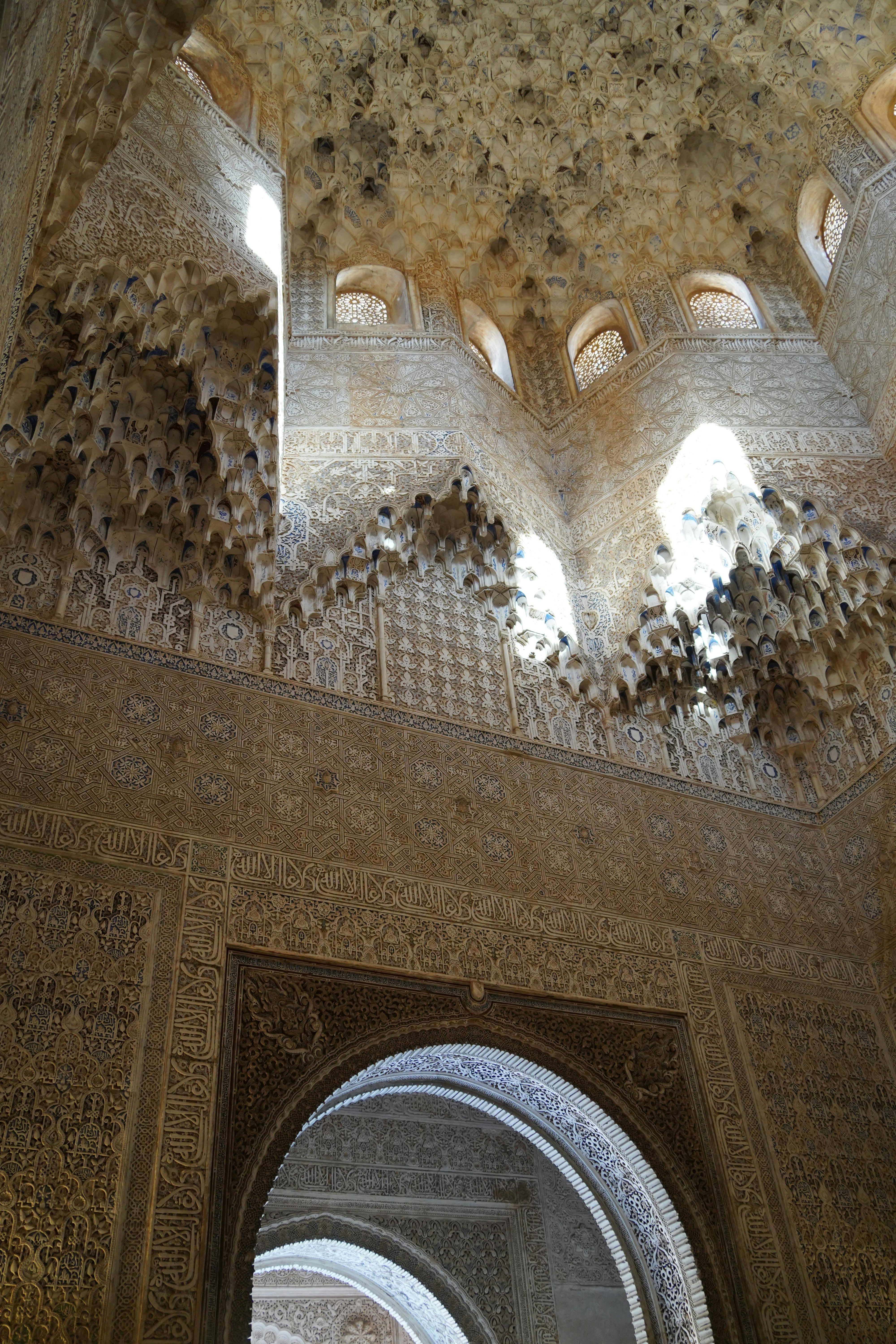 The ceiling of a building with a clock on it