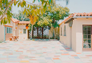A house with a tiled patio and trees
