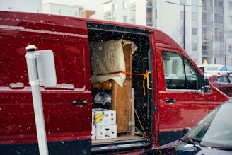A red van is parked on the side of the road