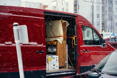 A red van is parked on the side of the road