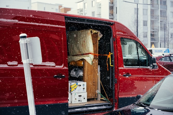 A red van is parked on the side of the road
