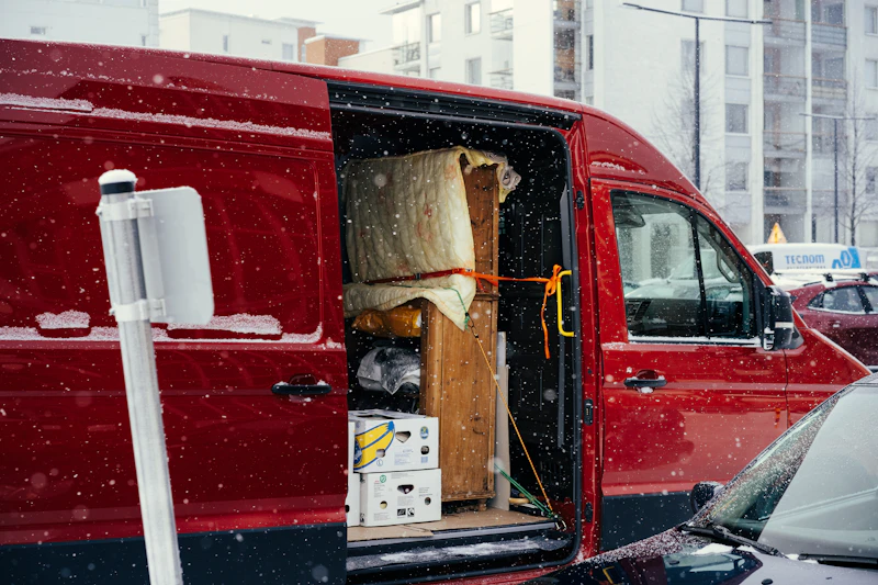 red moving van loaded with furniture at the curb