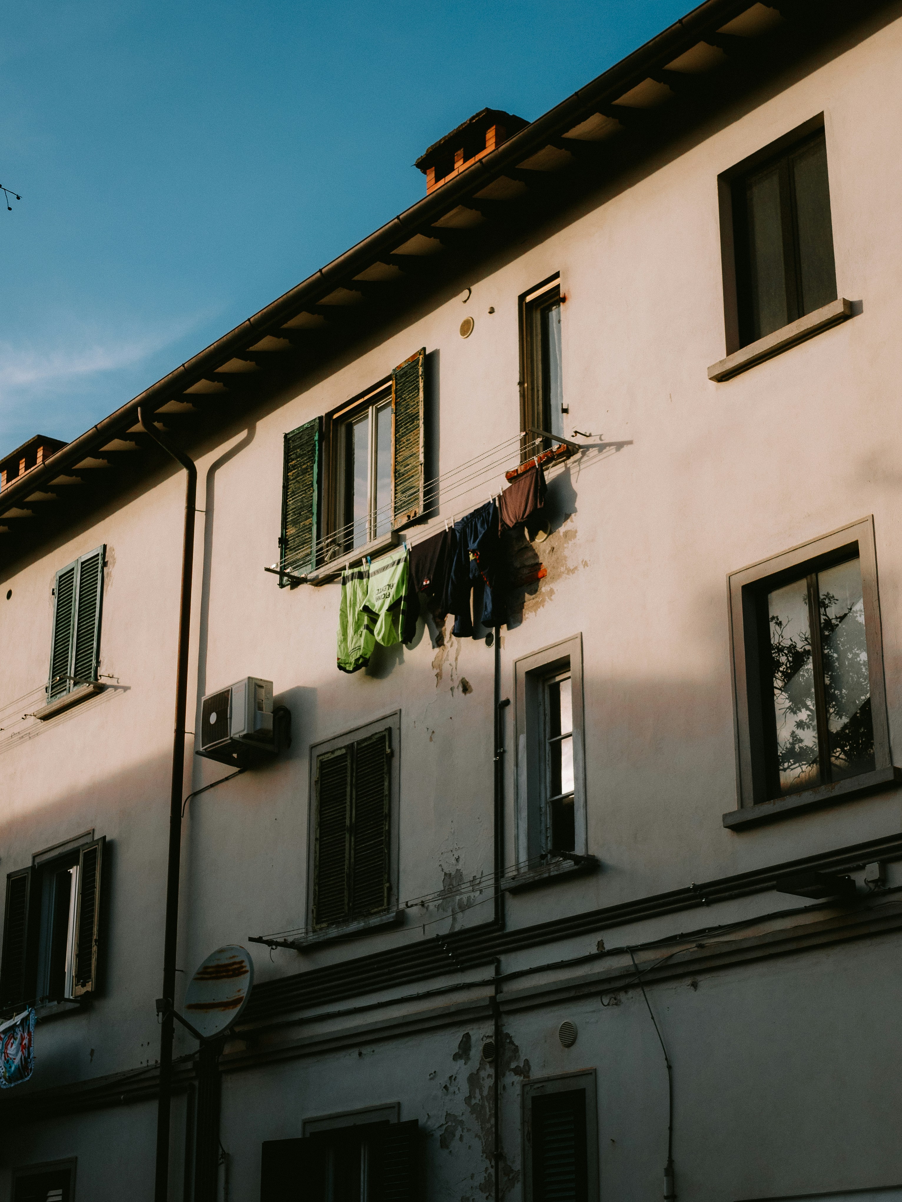 A building with clothes hanging out of the windows