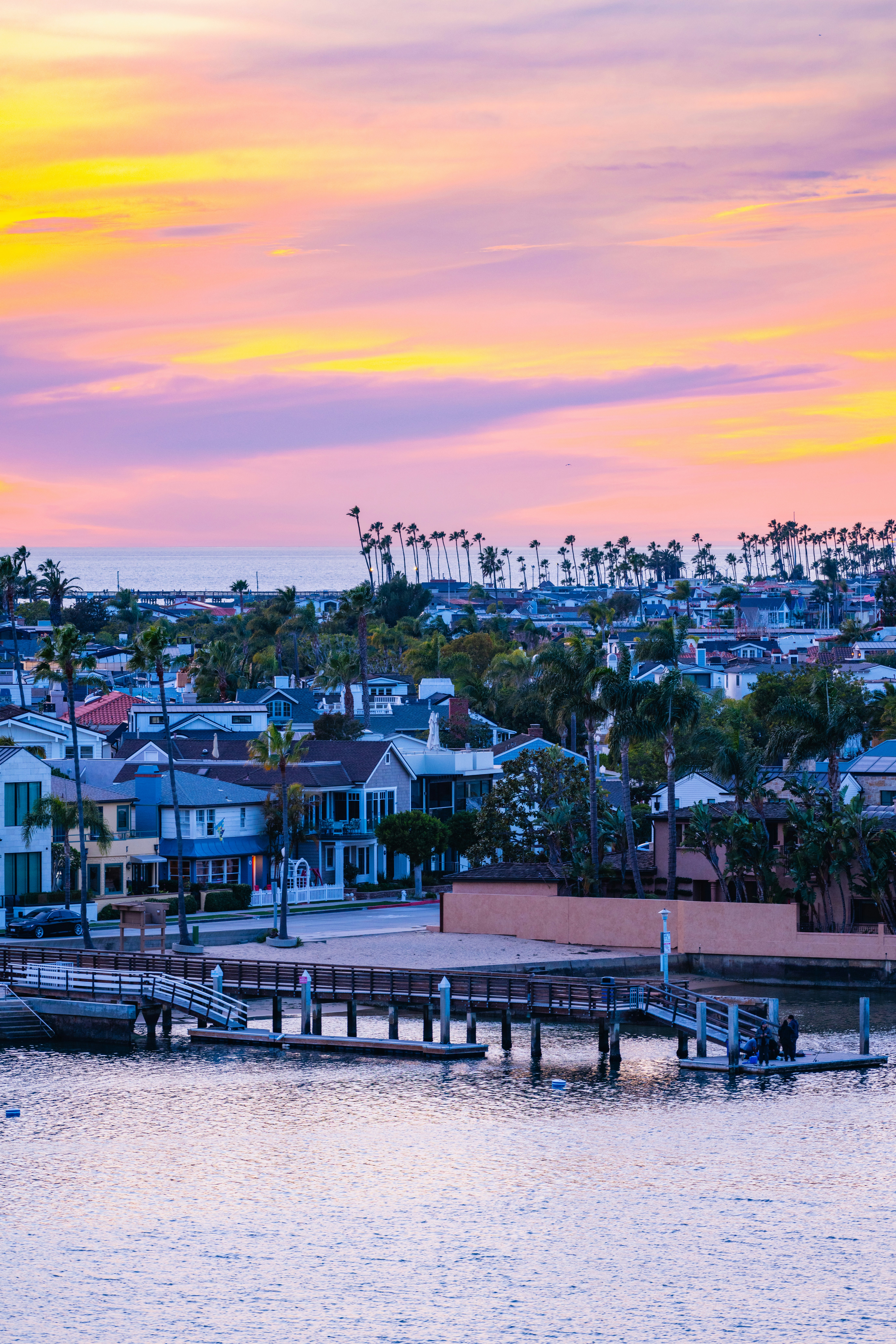 A view of a city from the water at sunset