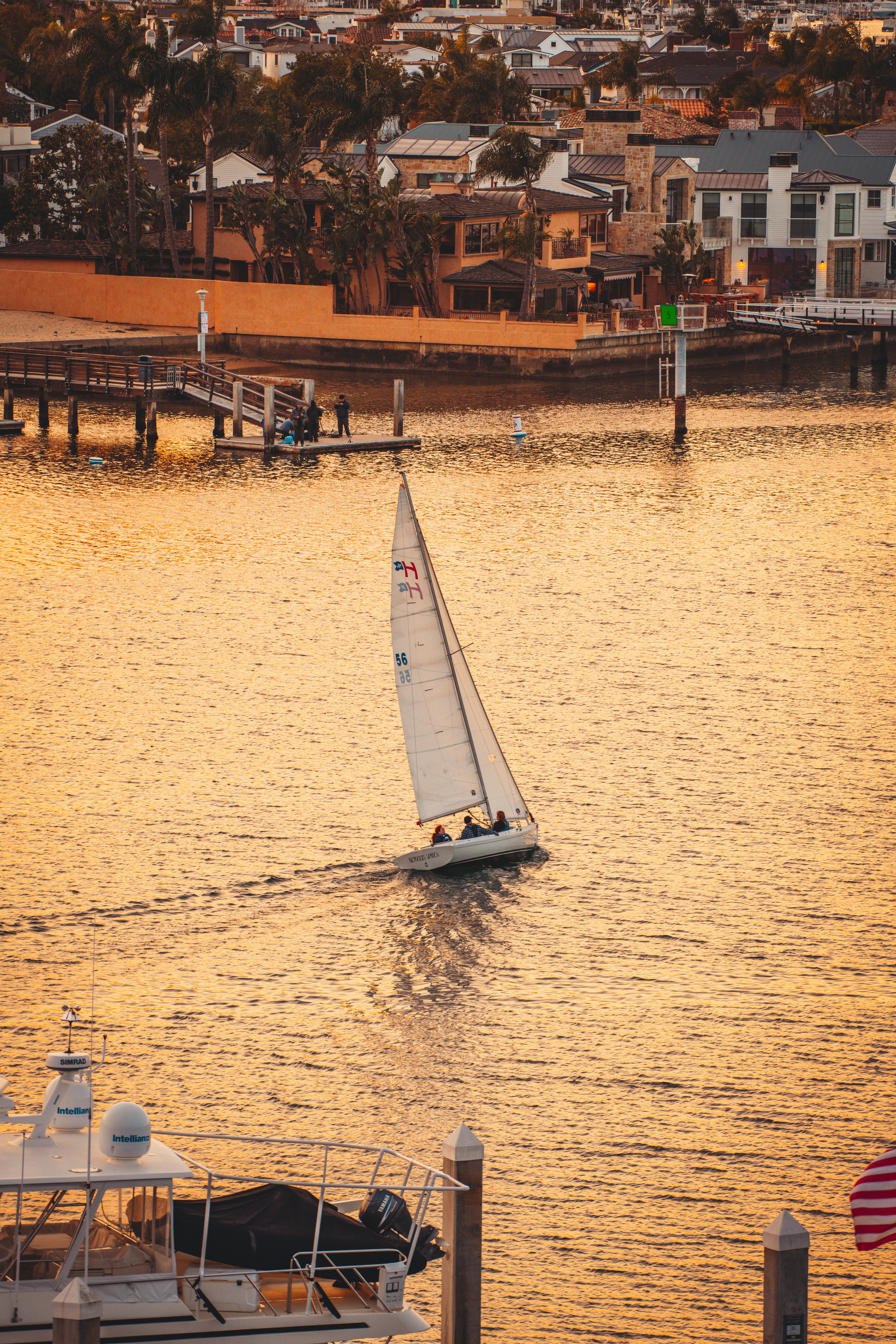 A sailboat in the water with a city in the background