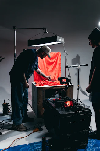A group of people standing around a camera