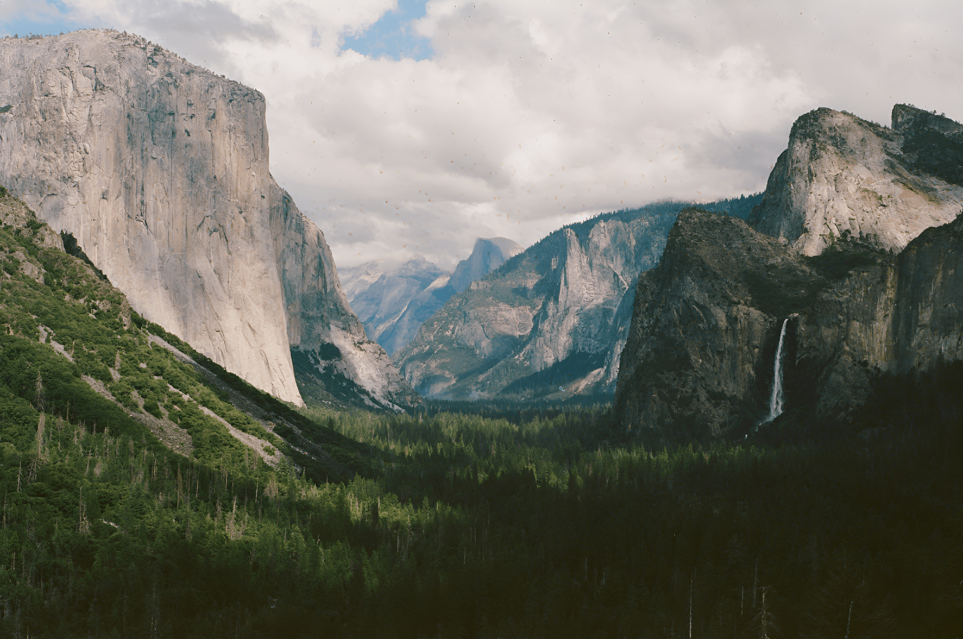 A view of a valley with mountains in the background