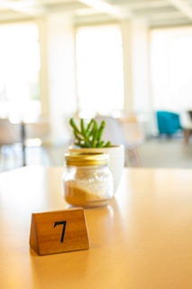 A wooden block with a number seven on it sitting on a table