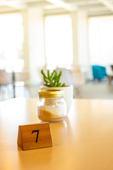 A wooden block with a number seven on it sitting on a table
