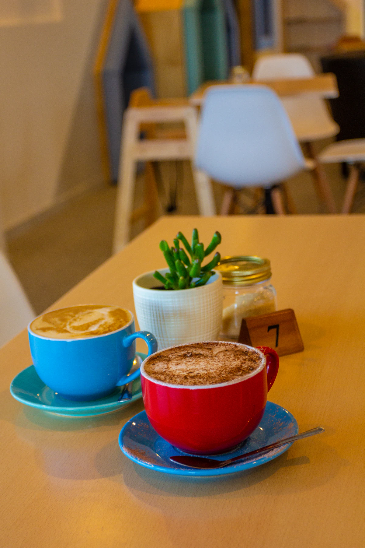 Two cups of coffee on a wooden table