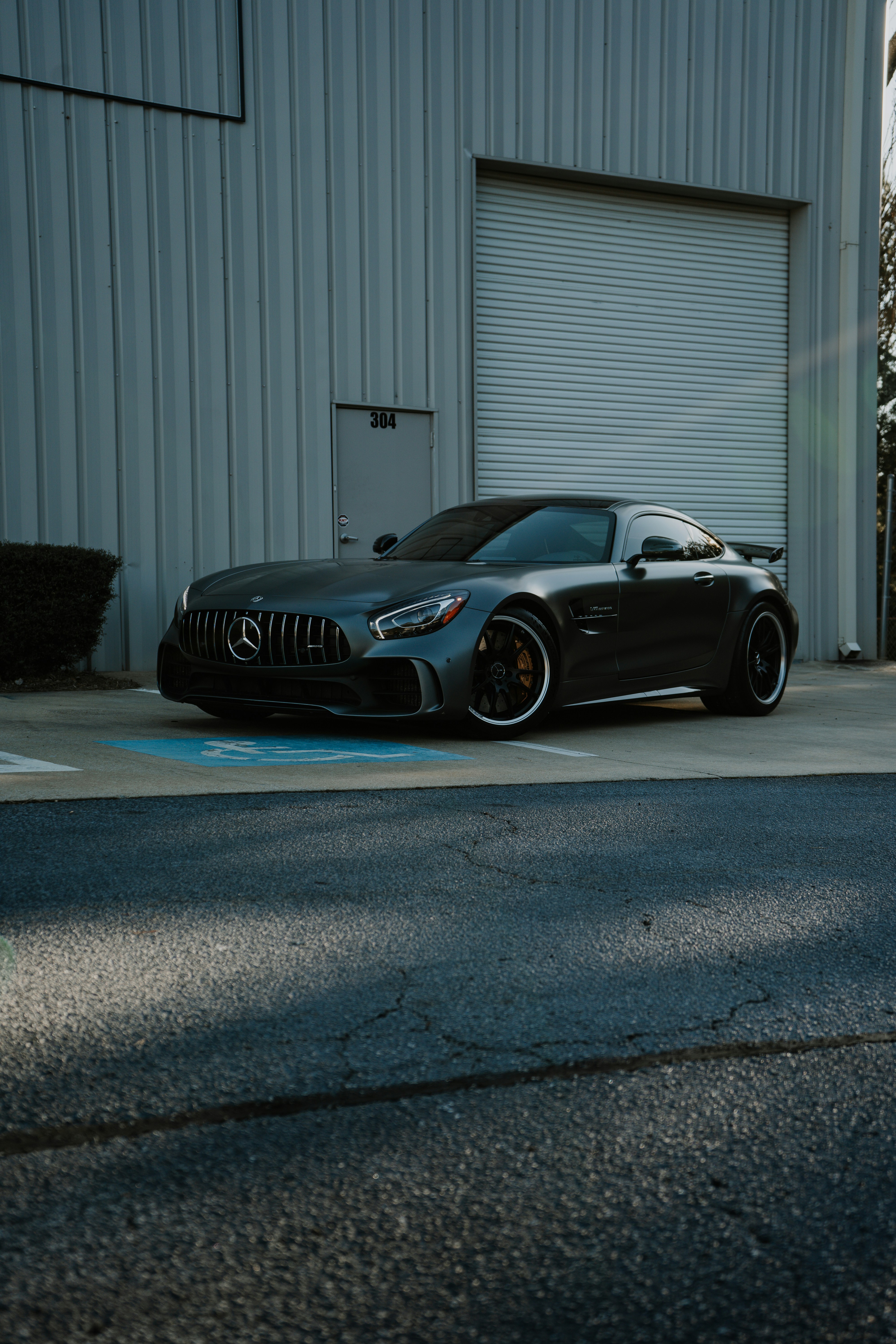 A black car parked in front of a building photo – Free Car Image on ...