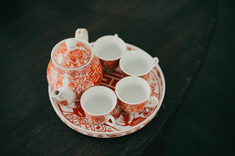 Red and white tea set on a wooden table