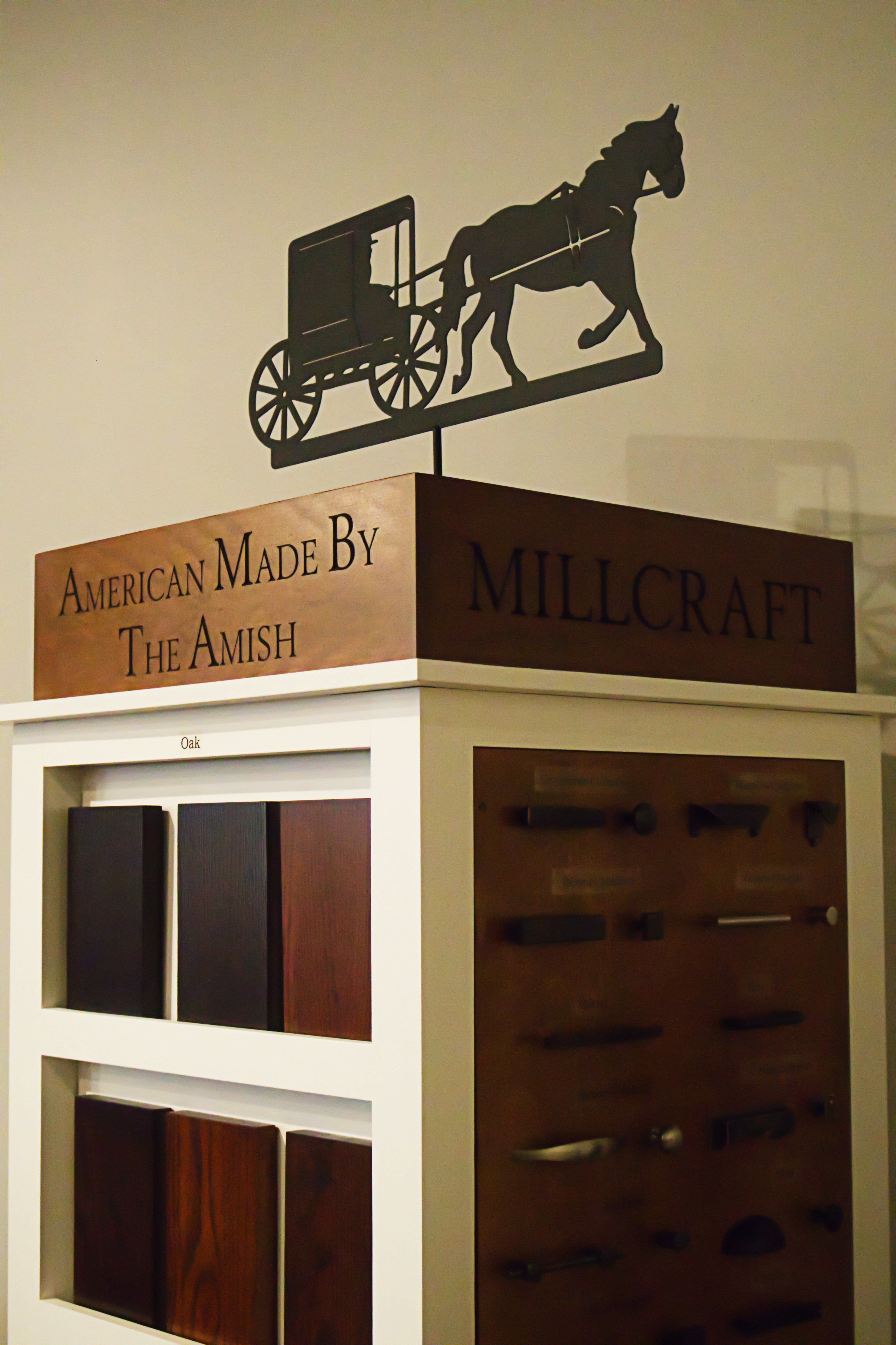 A horse drawn carriage on top of a book shelf